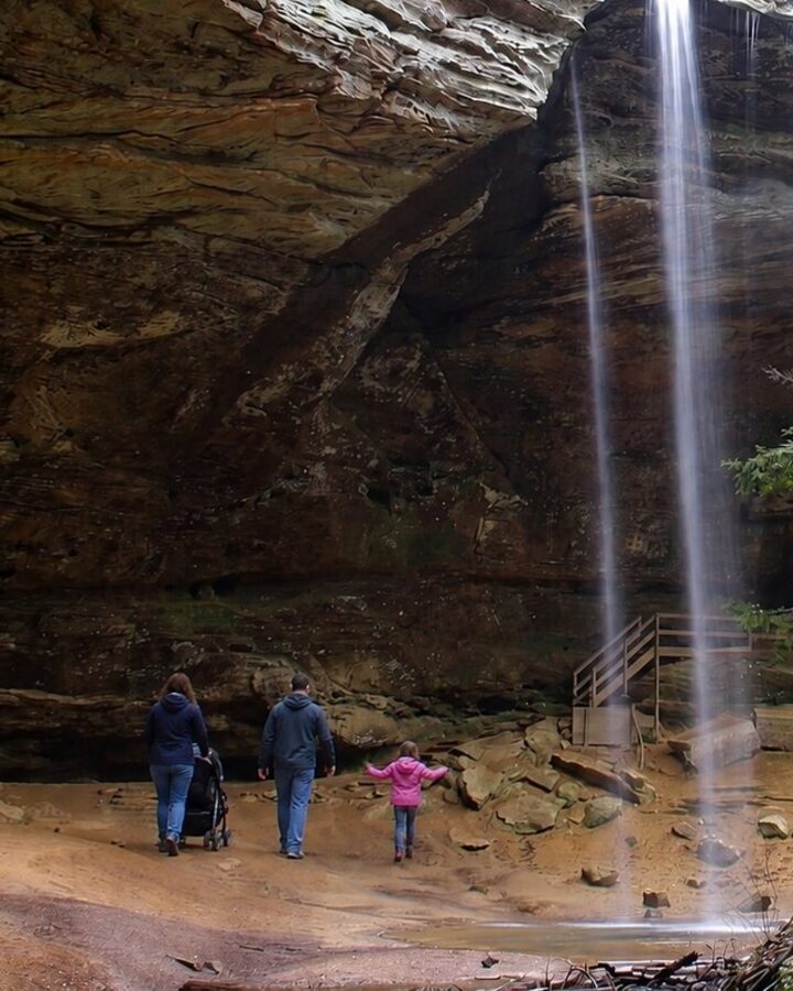 A family with a stroller under Ash Cave